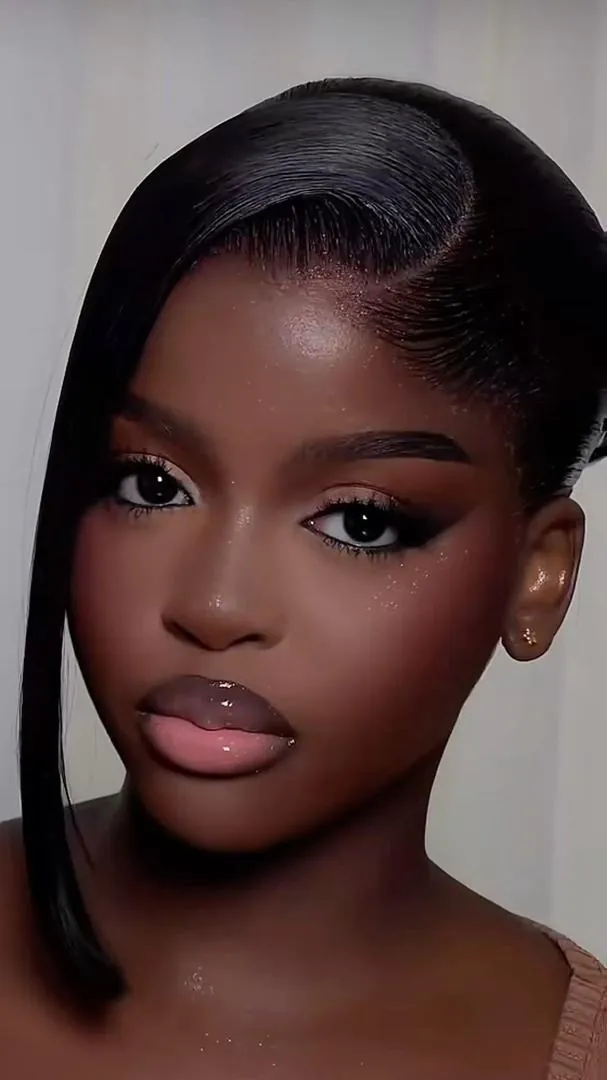 Glass skin makeup finish with a sleek side-parted style