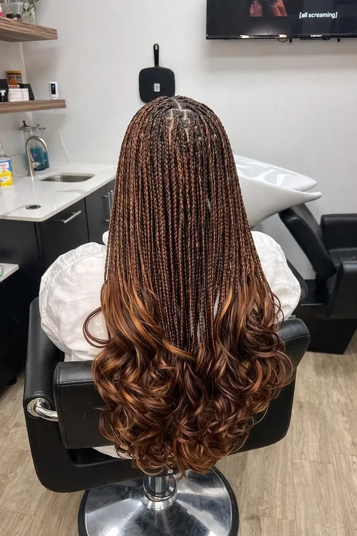 Knotless braids styling with curled ends finished at CRYSTAL